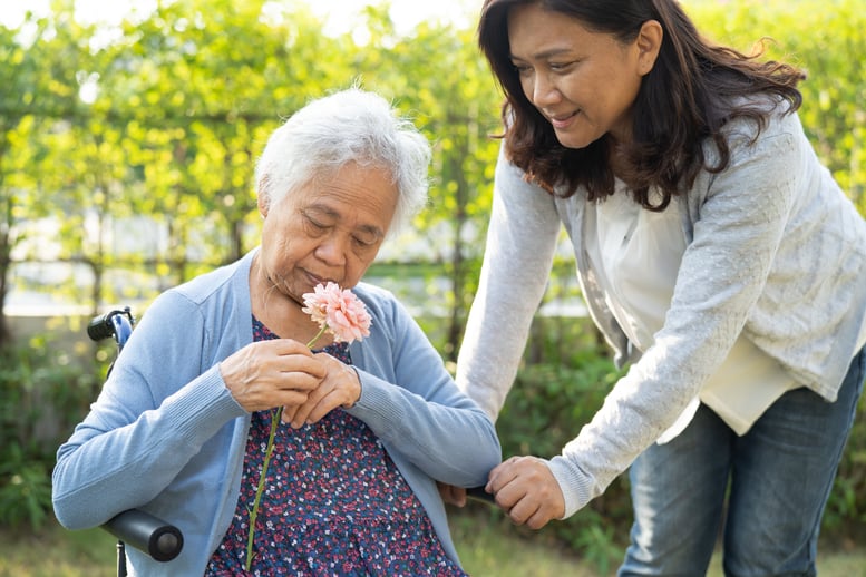 asian-senior-woman-holding-red-rose-flower-smile-2026-01-09-10-52-53-utc
