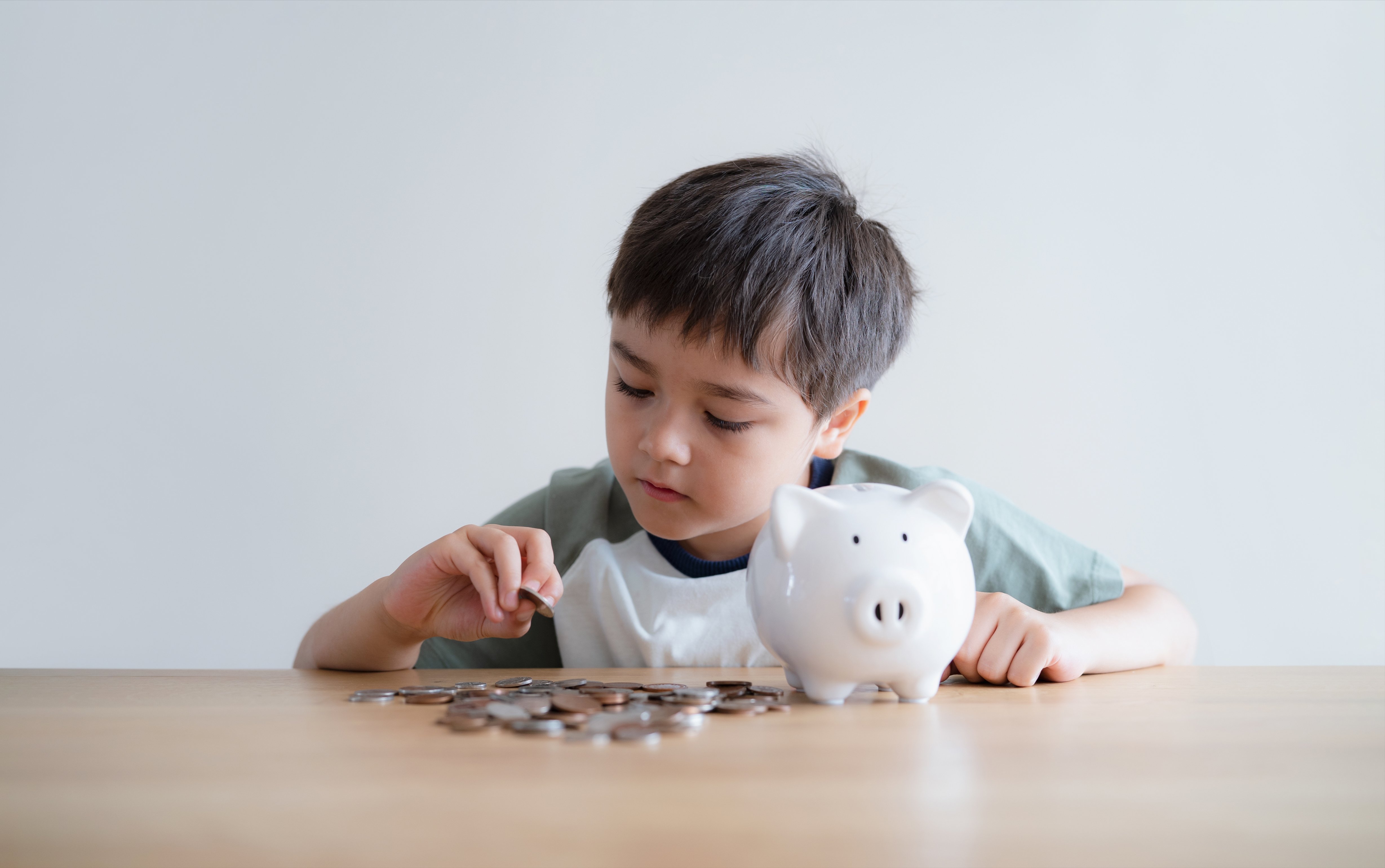 child-boy-putting-coins-into-piggy-bank-child-cou-2026-03-19-07-06-49-utc