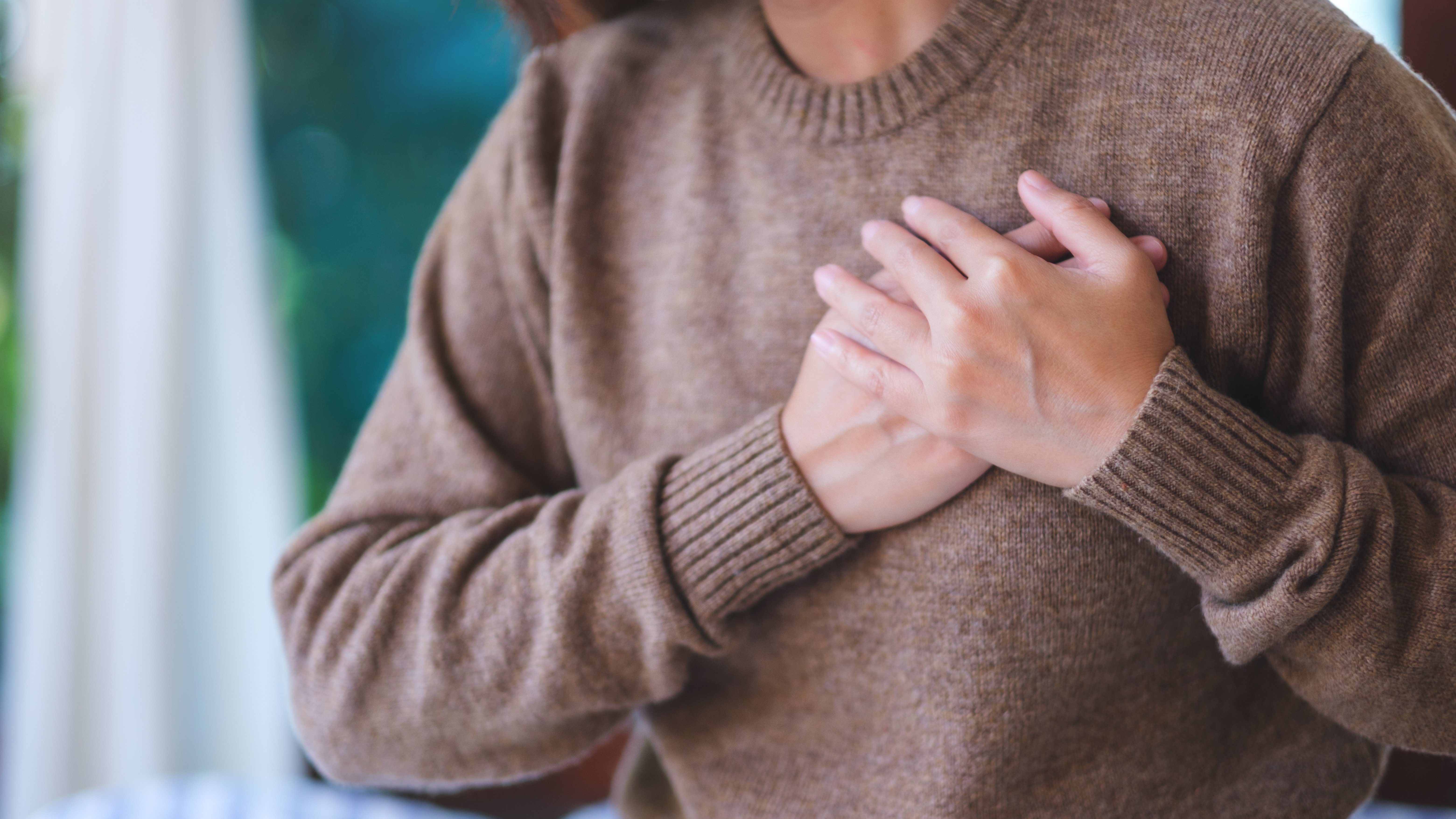closeup-image-of-a-woman-with-hands-on-chest-sudd-2026-03-08-23-03-53-utc