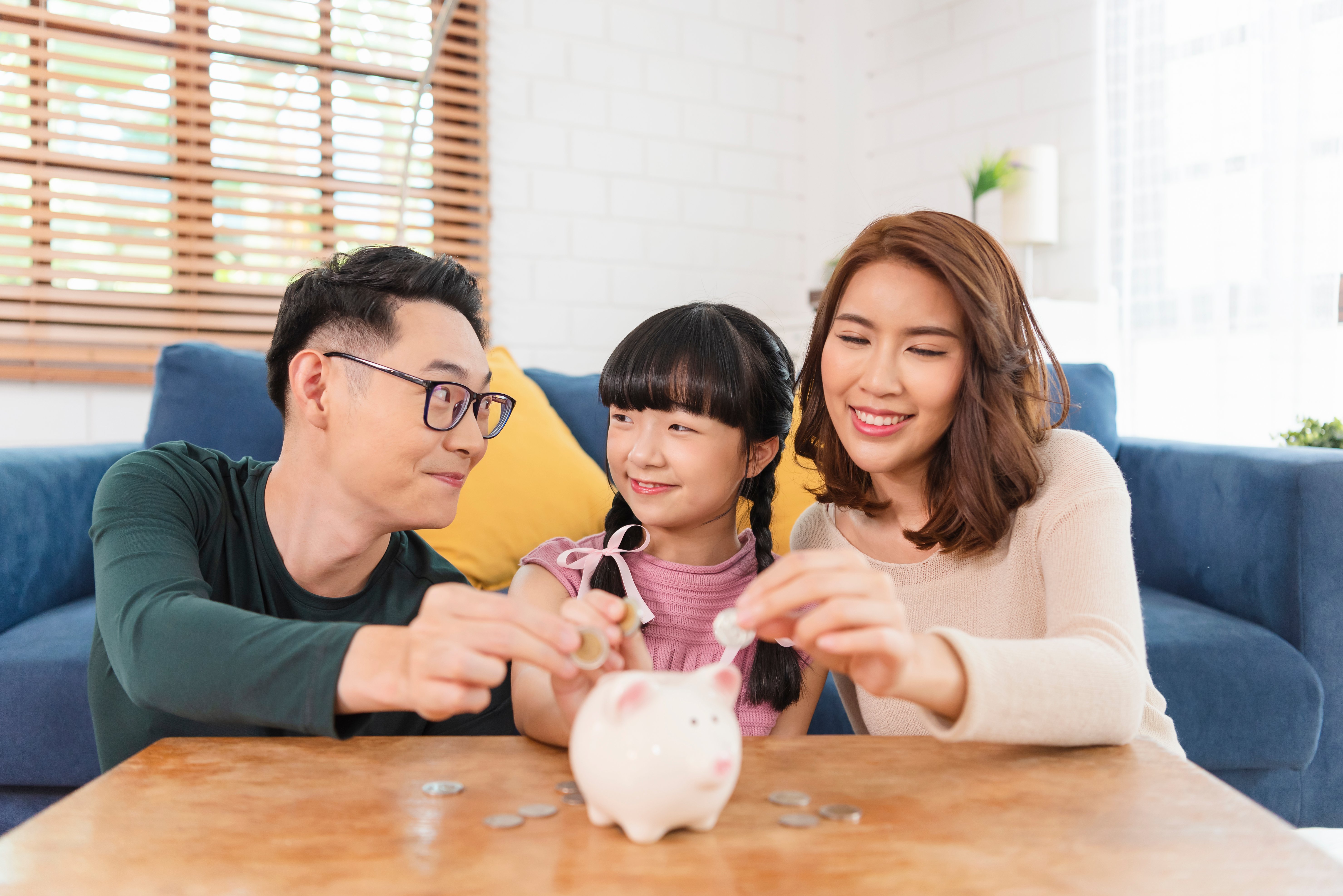 happy-asian-family-saving-money-in-piggy-bank-pig-2026-01-06-09-34-12-utc
