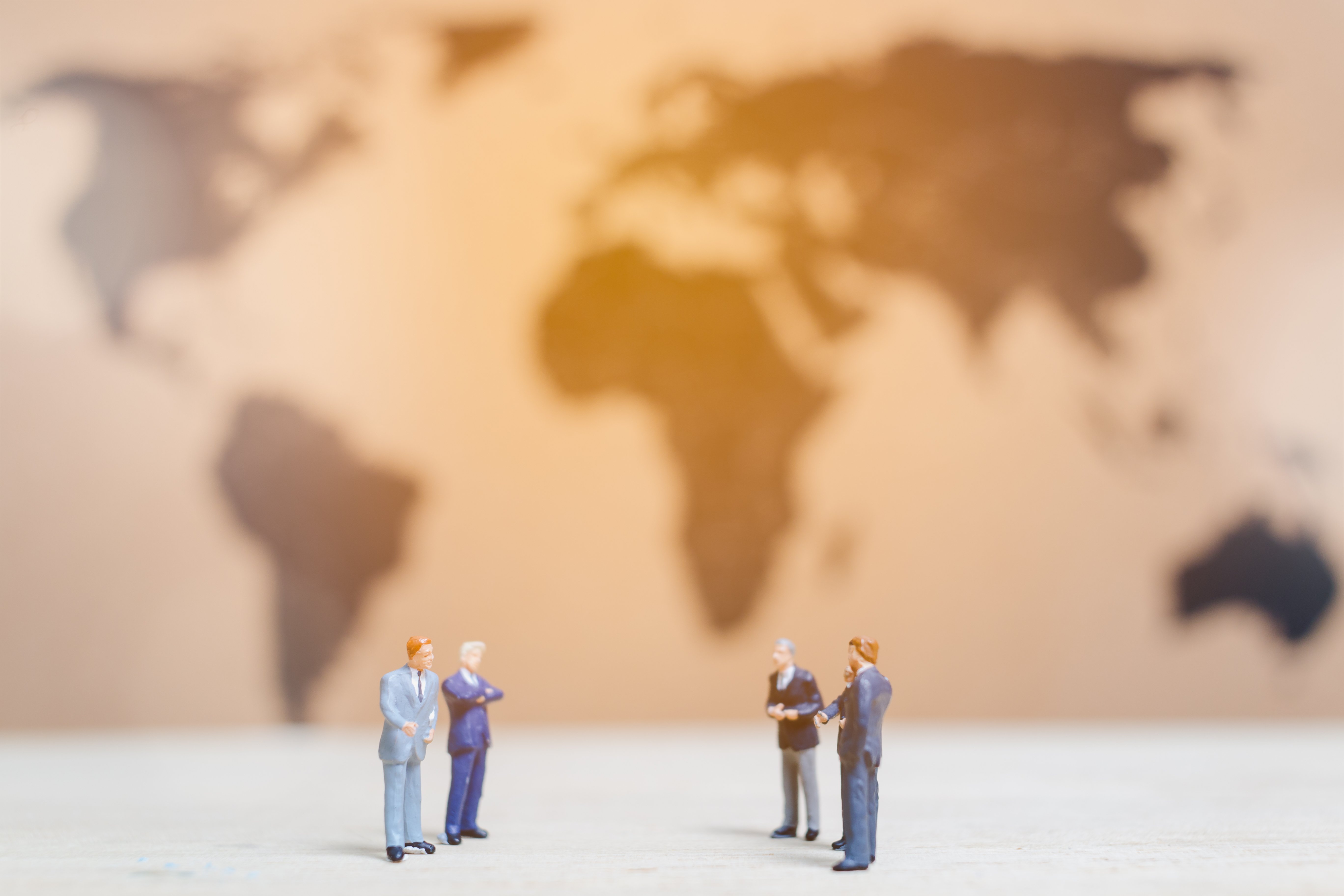 miniature-people-businessman-standing-on-world-ma-2026-03-26-06-40-35-utc