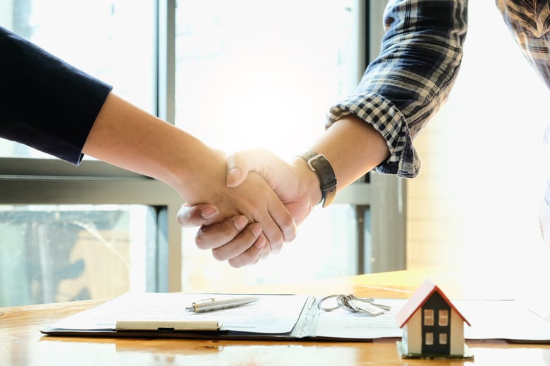 real-estate-agent-and-customers-shaking-hands-toge-2026-03-17-00-04-09-utc