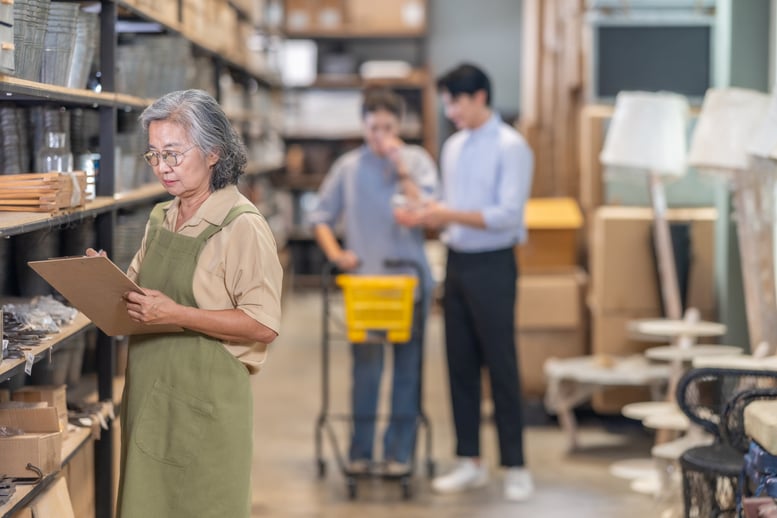 senior-female-ceramic-owner-assists-couple-in-fami-2026-03-08-23-00-46-utc